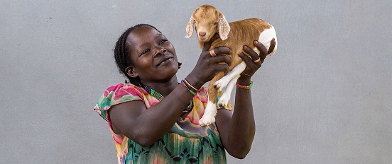 Dawunda holding a goat in Ethiopia.