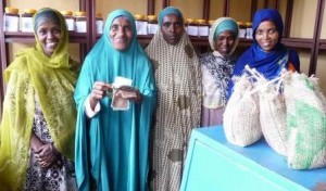 Chairwoman of the Adiburu Women's Co-operative counts the money made in her shop thanks to sales of honey and wild coffee