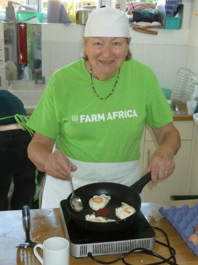 Linda frying an egg.