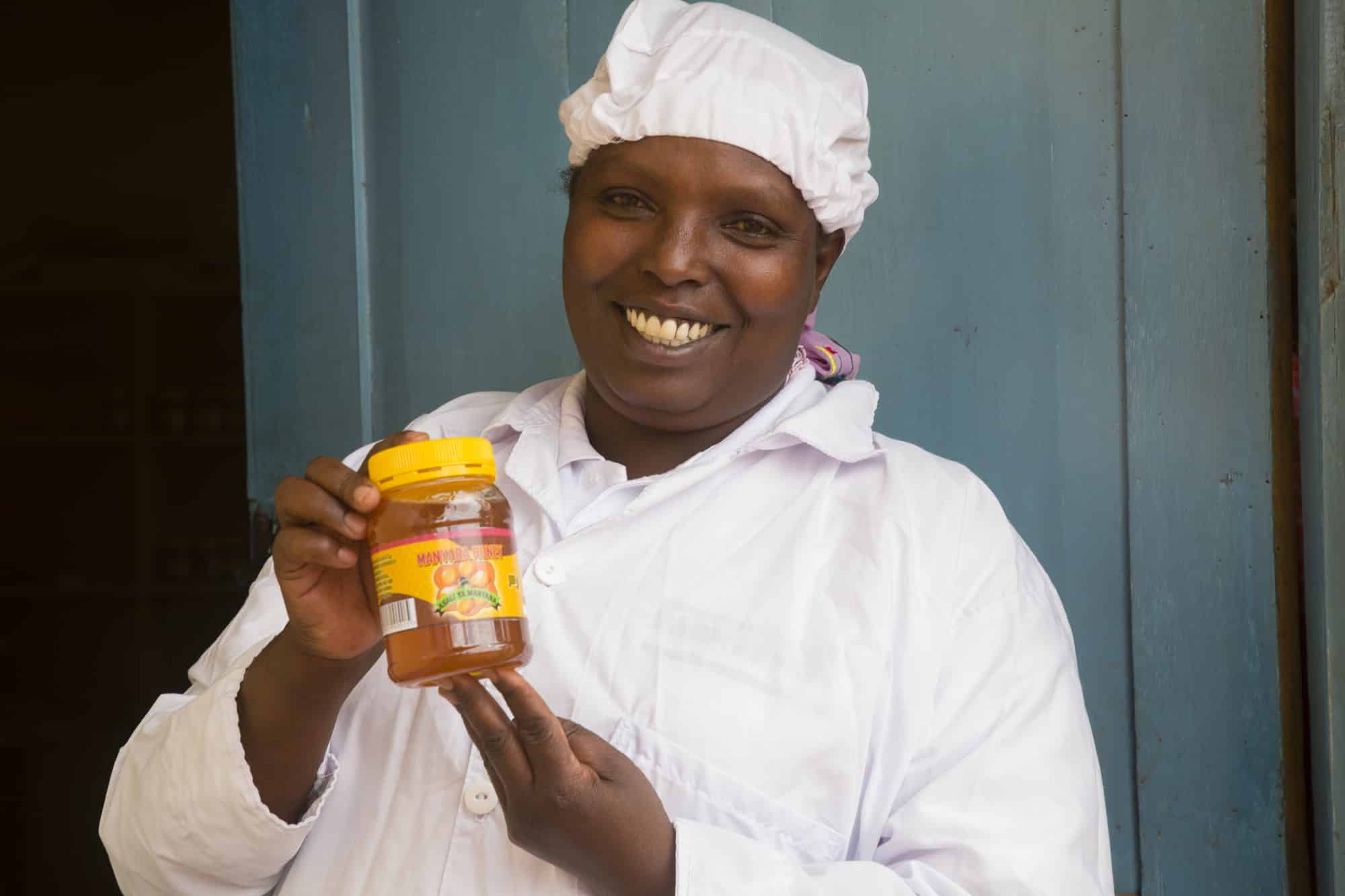 Lucia with honey made by a beekeeping group in Tanzania.