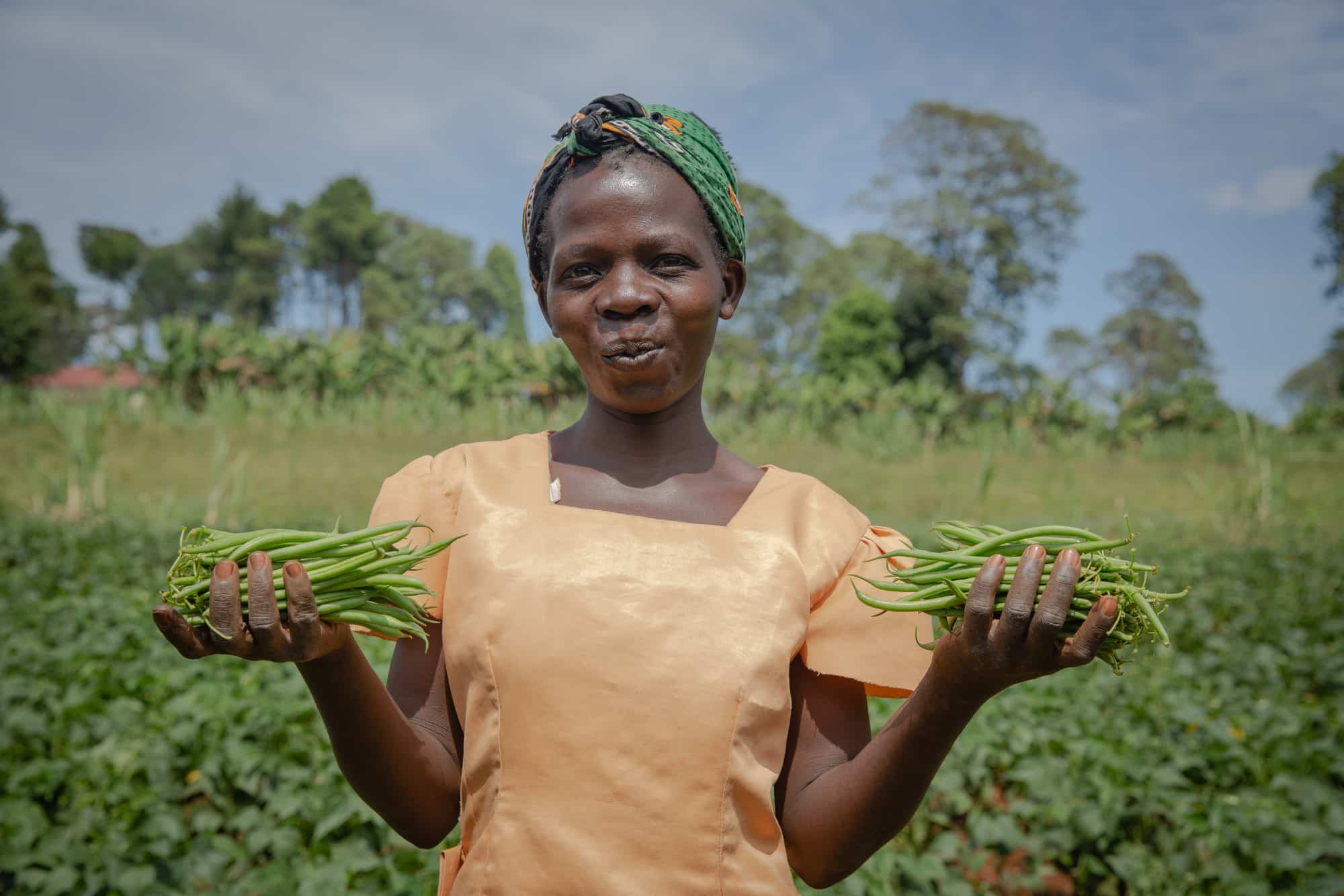 Susan, a farm worker harvesting green beans in Kenya.