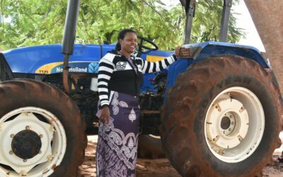 39-year-old Jenifa in front of her tractor.